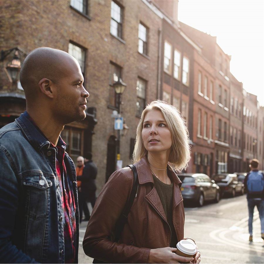 Friends taking a stroll with a cup of coffee